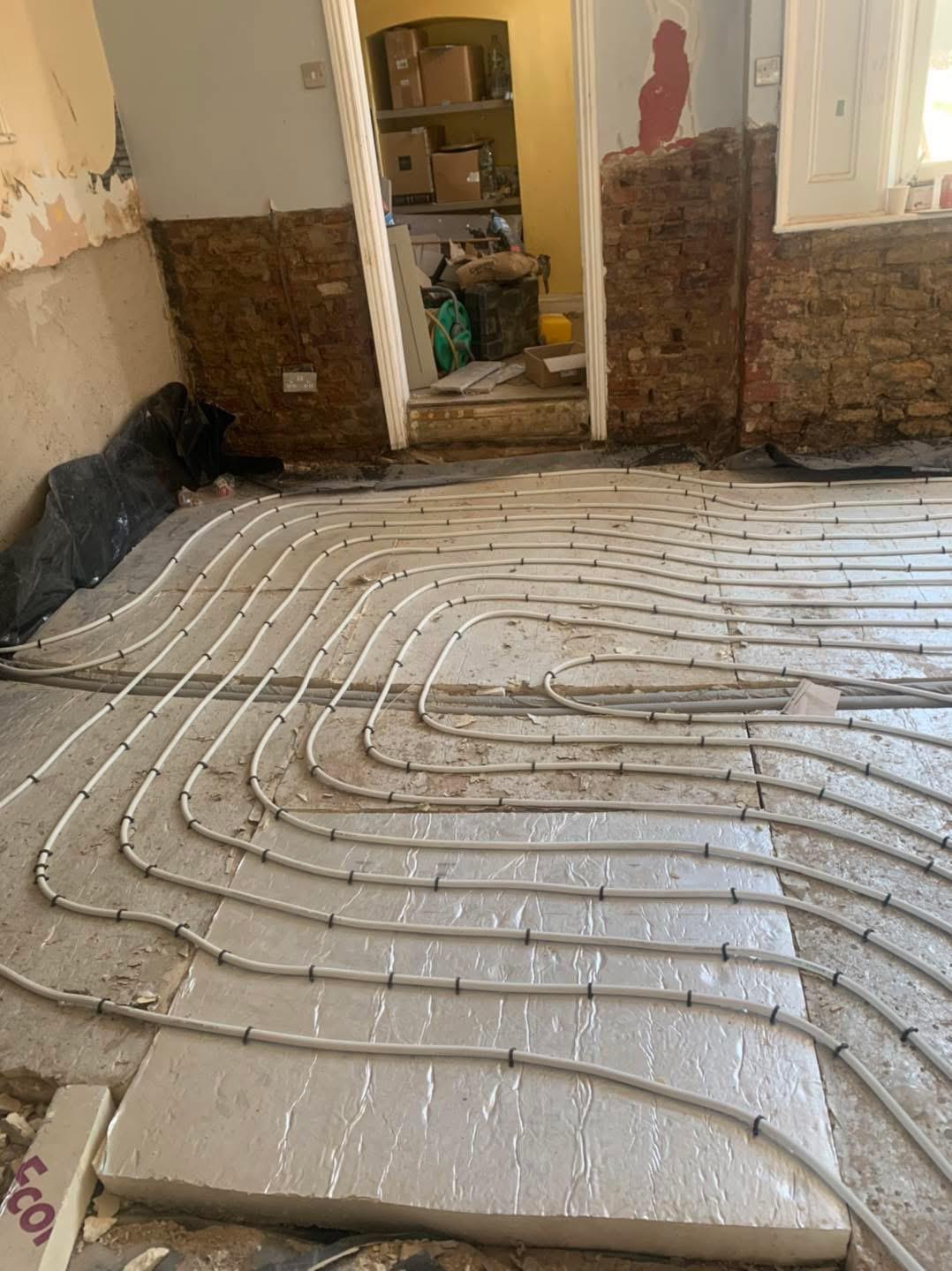Wet underfloor heating pipework laid on insulated subfloor